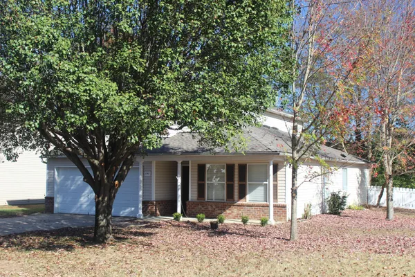 a house with a tree in front of it