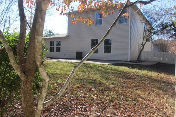 a house that has a tree in front of it