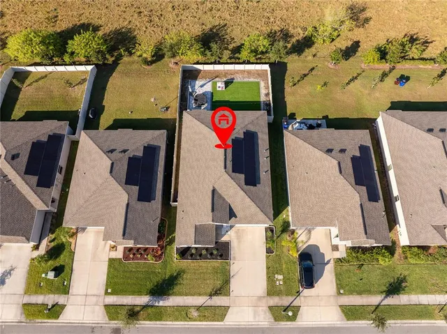 an aerial view of houses with outdoor space