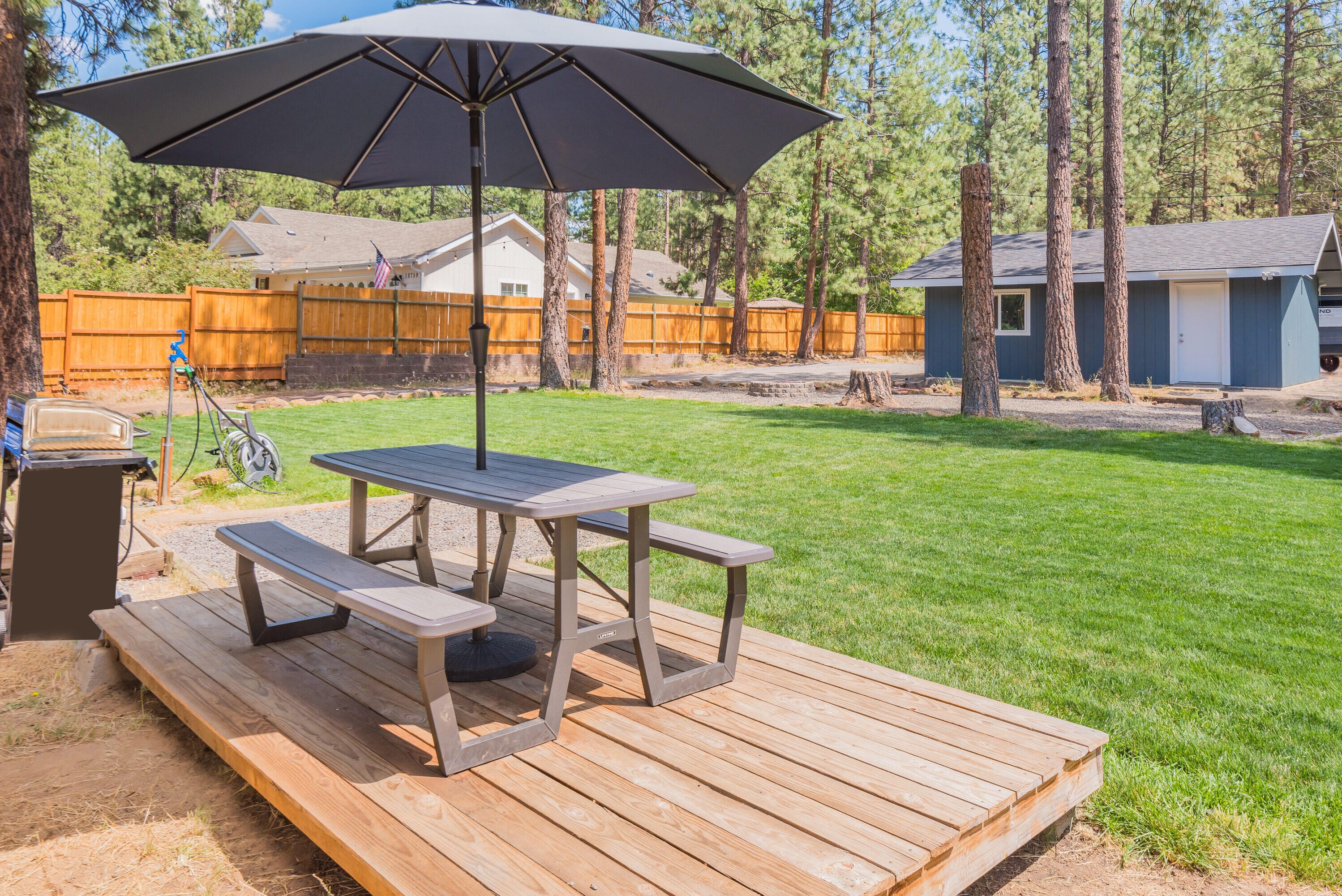 18749 Choctaw Road Bend, OR 97702 - Photo 17 of 22 a view of a deck with furniture and a yard