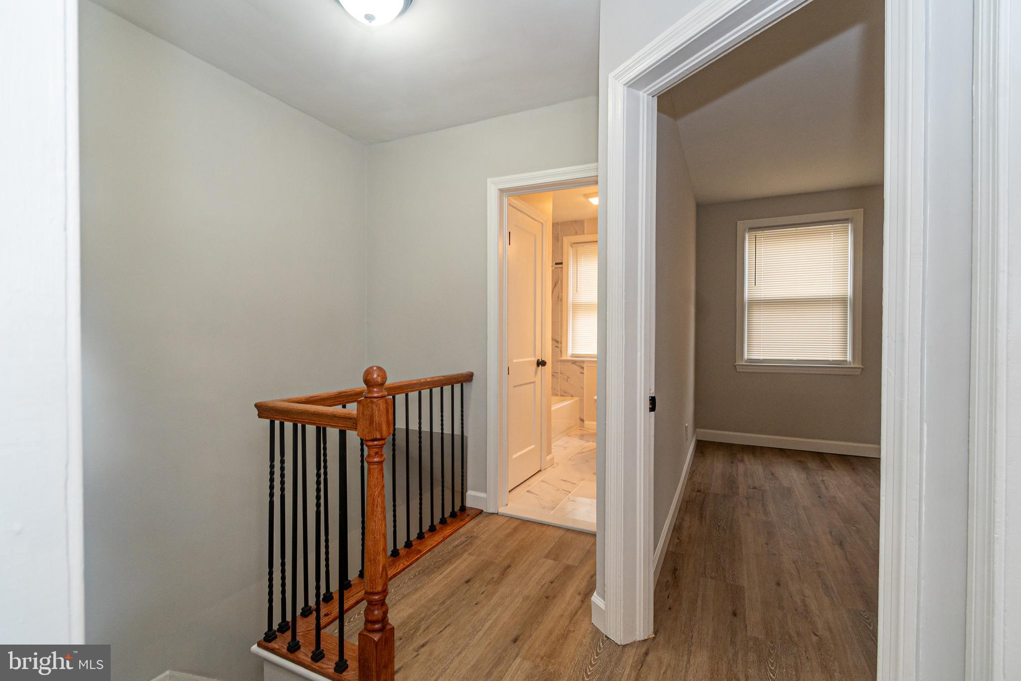 3716 Columbus Drive Baltimore, MD 21215 - Photo 13 of 36 a view of a hallway with wooden floor and a window