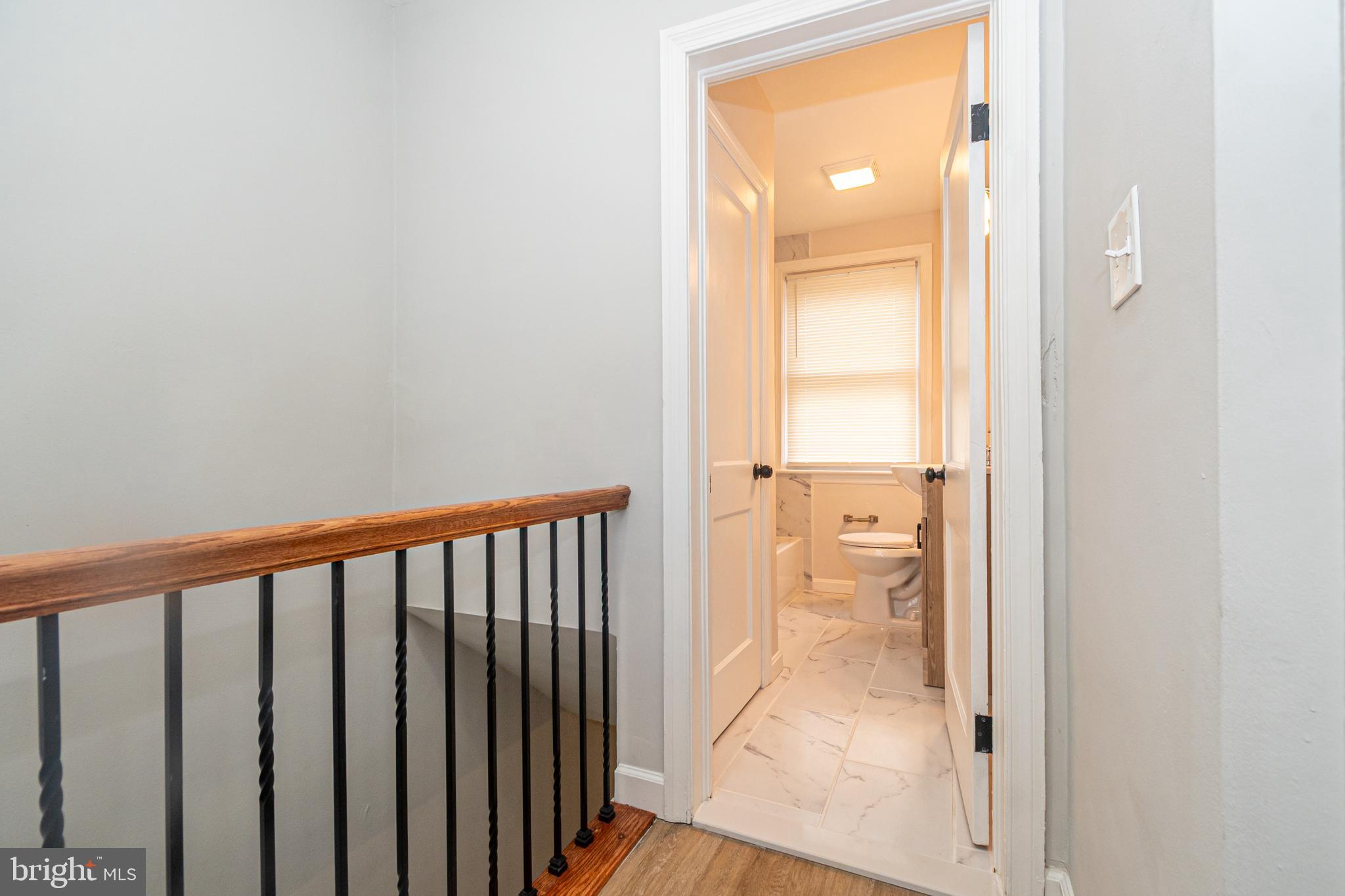 3716 Columbus Drive Baltimore, MD 21215 - Photo 14 of 36 a view of a hallway with a glass door and a window