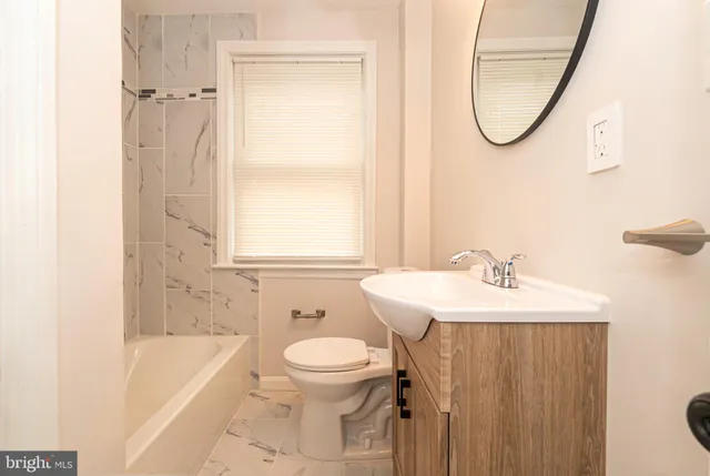 a bathroom with a sink a toilet and a bathtub