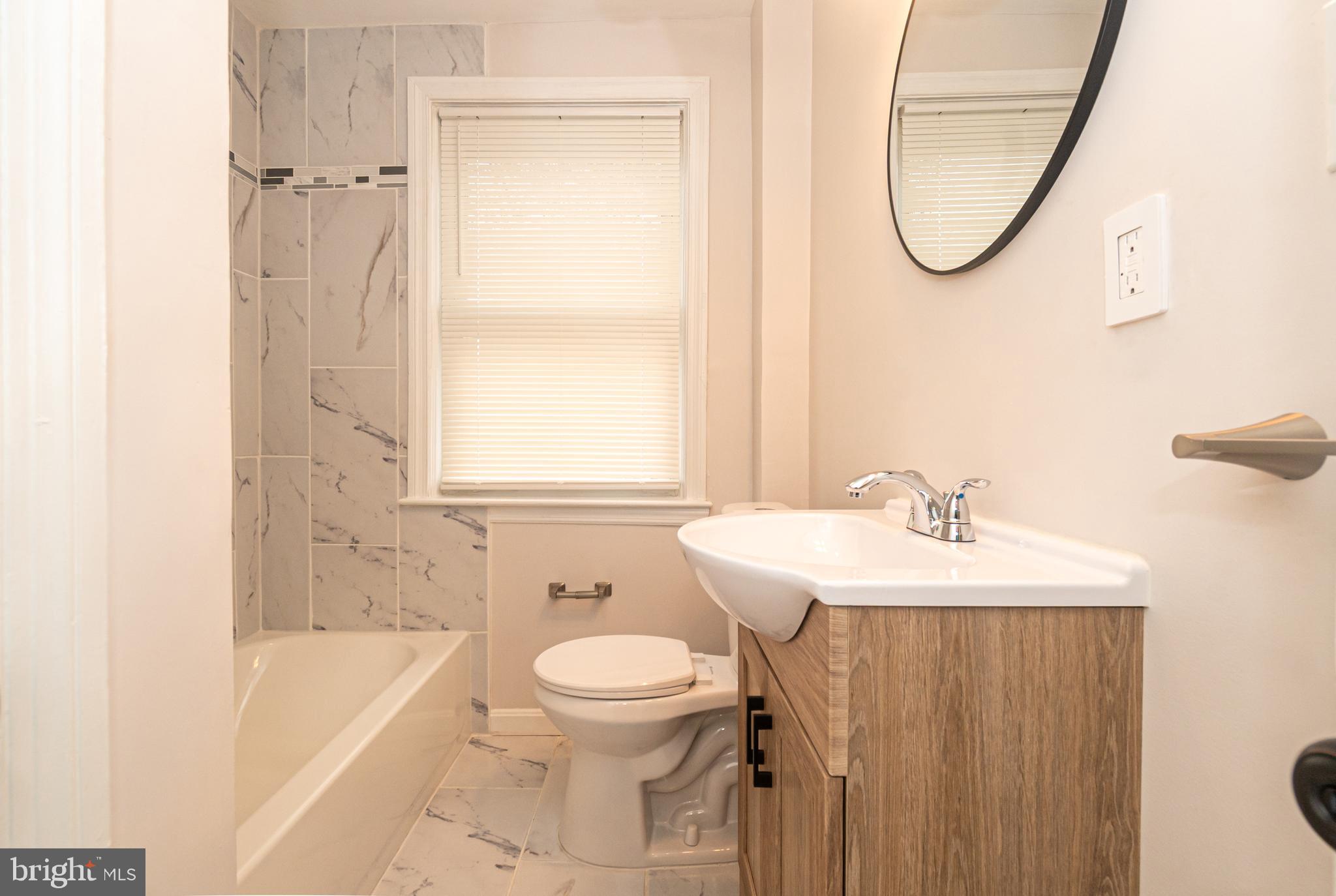 3716 Columbus Drive Baltimore, MD 21215 - Photo 15 of 36 a bathroom with a sink a toilet and a bathtub