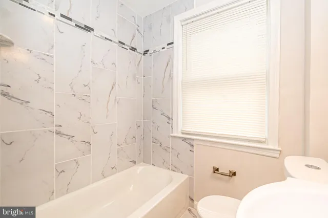 a bathroom with a bathtub and shower