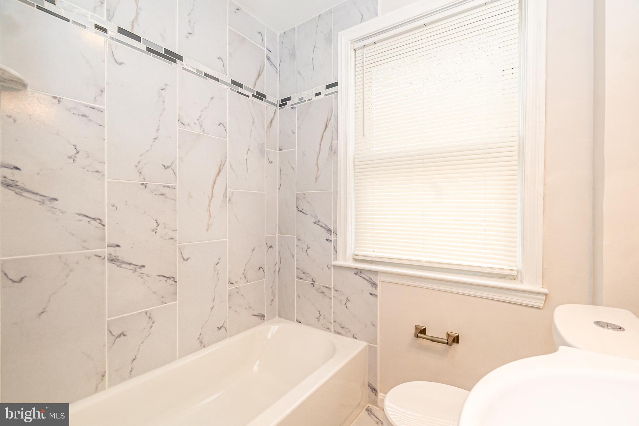 3716 Columbus Drive Baltimore, MD 21215 - Photo 16 of 36 a bathroom with a bathtub and shower