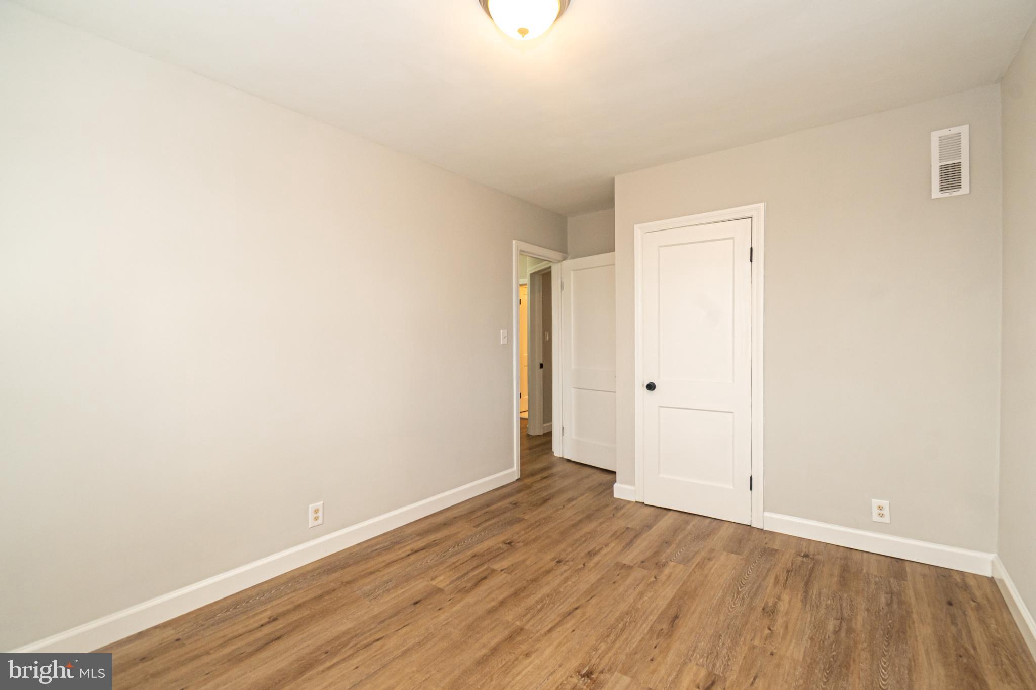 3716 Columbus Drive Baltimore, MD 21215 - Photo 20 of 36 a view of an empty room with wooden floor