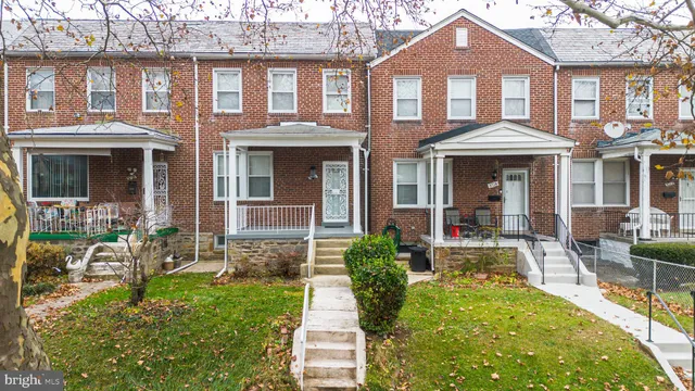 front view of a brick house with a yard
