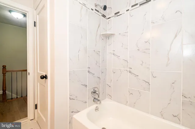 a bathroom with a bathtub and shower