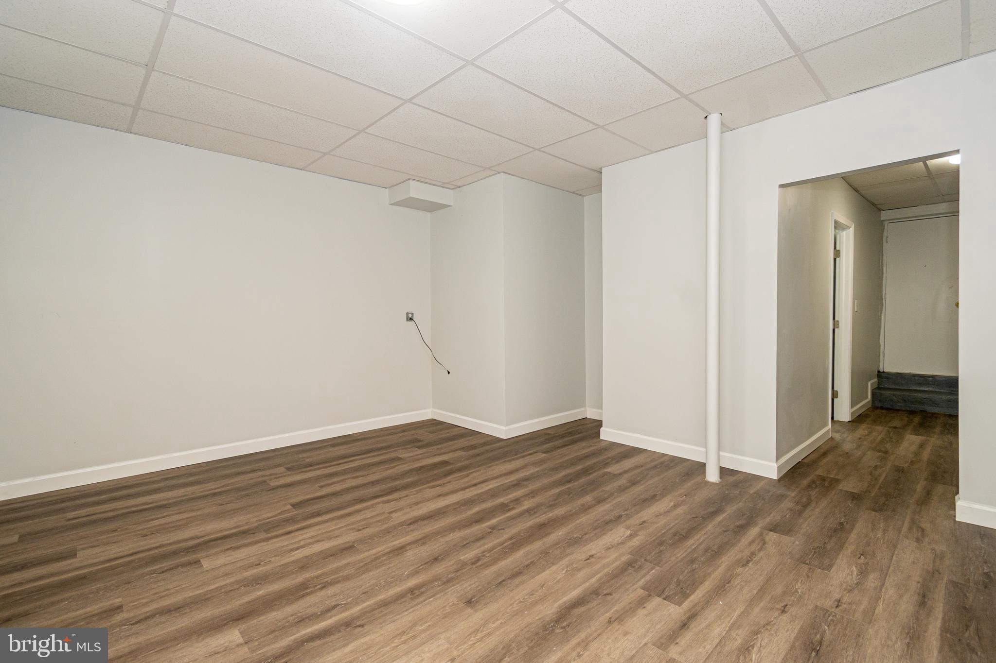 3716 Columbus Drive Baltimore, MD 21215 - Photo 25 of 36 a view of an empty room with wooden floor
