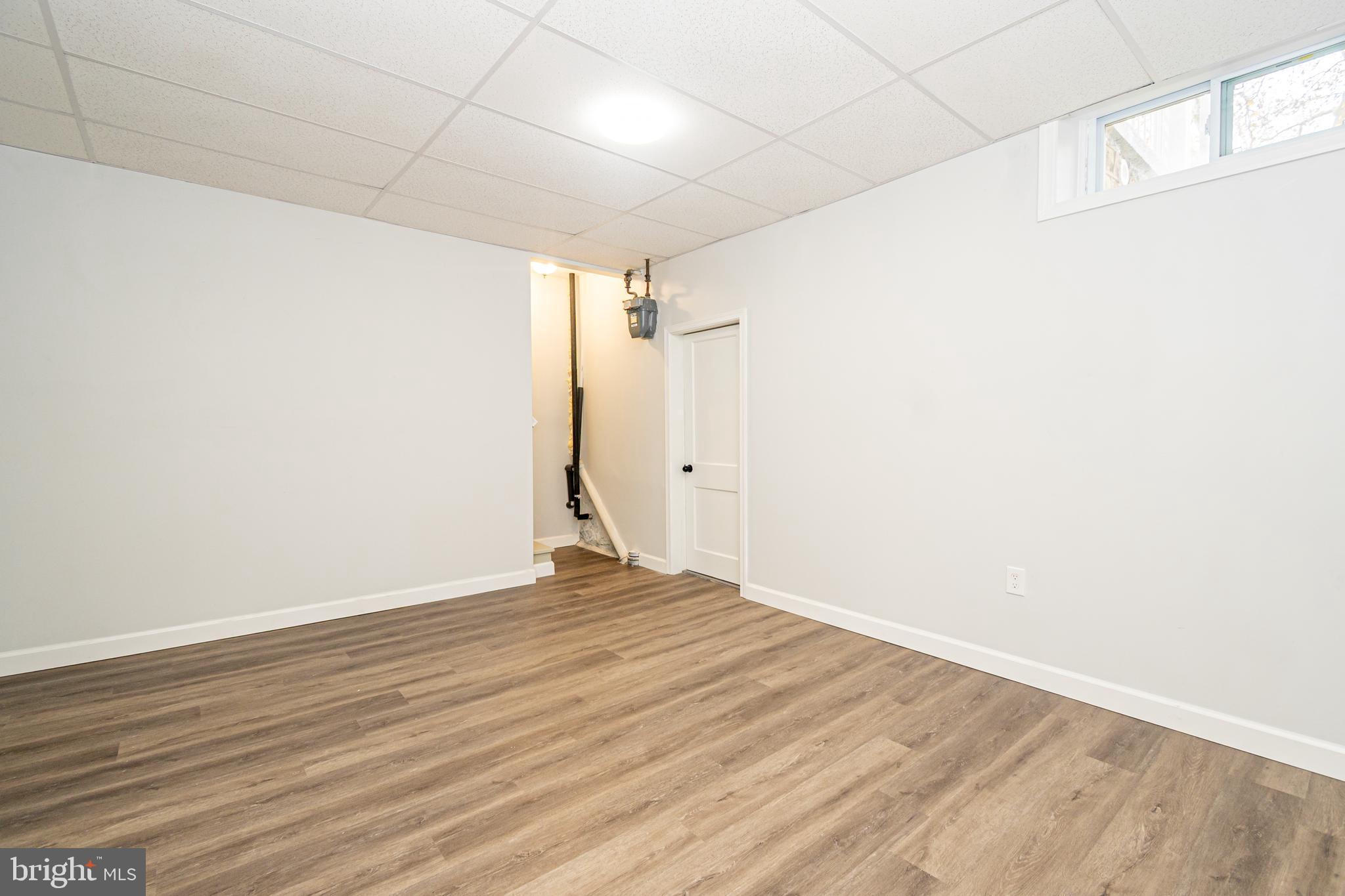 3716 Columbus Drive Baltimore, MD 21215 - Photo 26 of 36 a view of an empty room with wooden floor