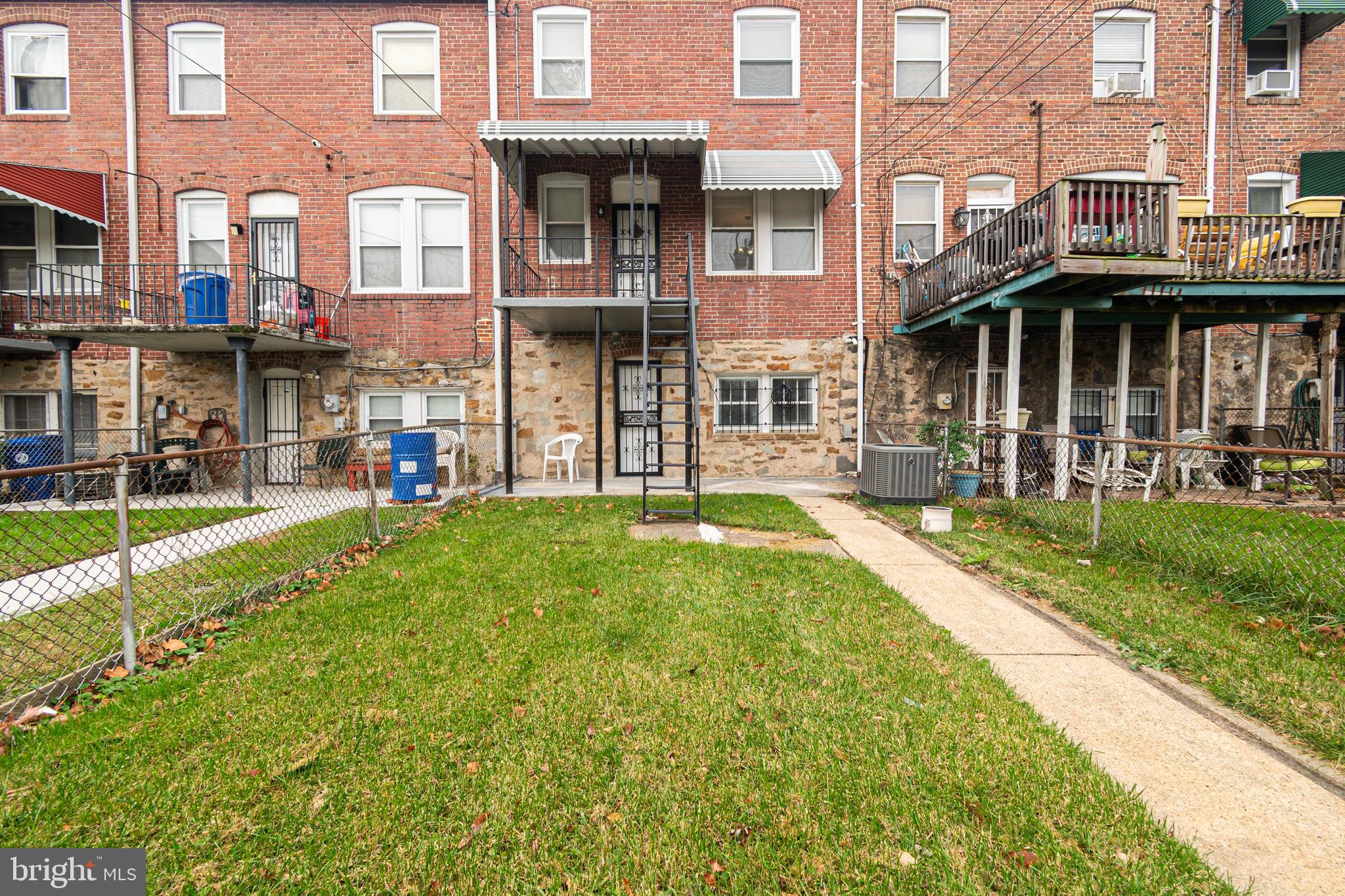 3716 Columbus Drive Baltimore, MD 21215 - Photo 34 of 36 a view of a building with a yard
