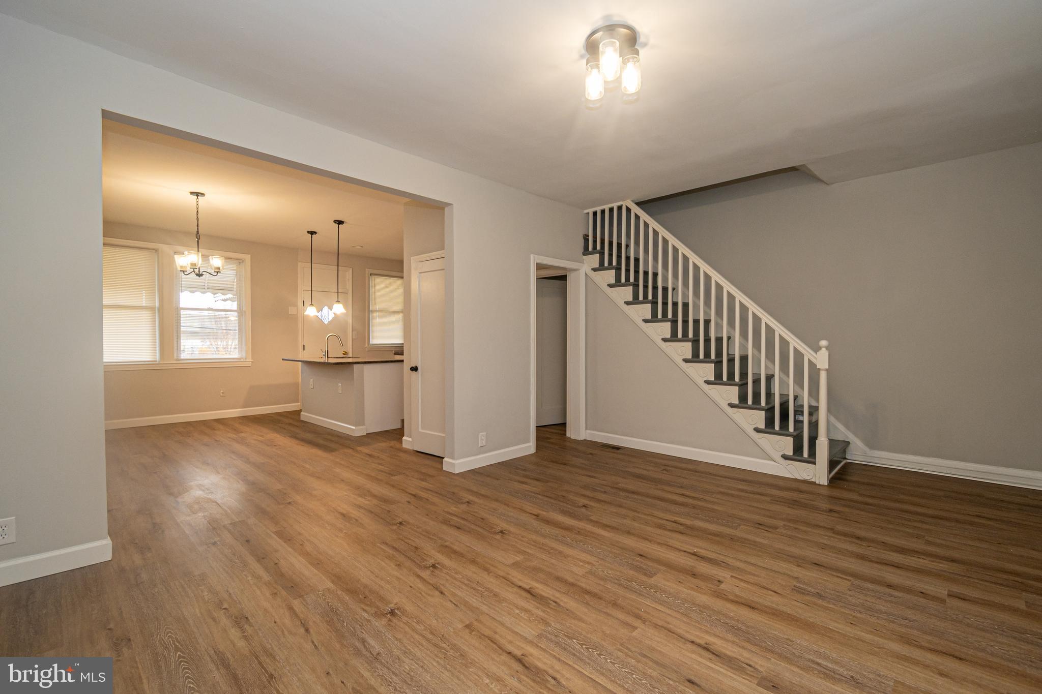 3716 Columbus Drive Baltimore, MD 21215 - Photo 5 of 36 a view of an empty room with wooden floor and a window