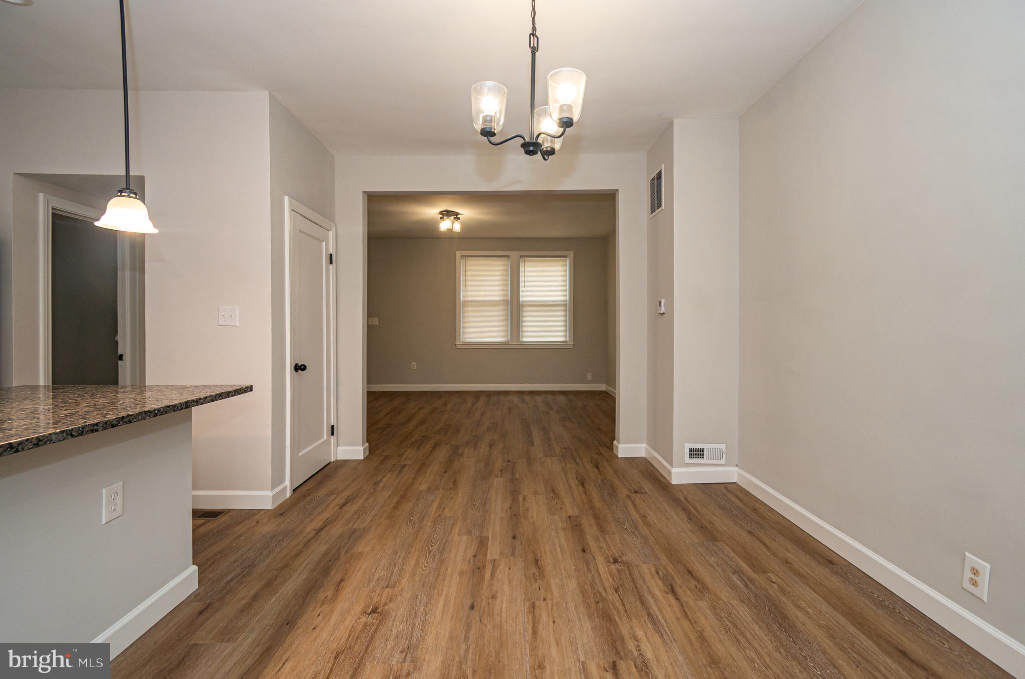 3716 Columbus Drive Baltimore, MD 21215 - Photo 7 of 36 a view of a room with wooden floor and staircase