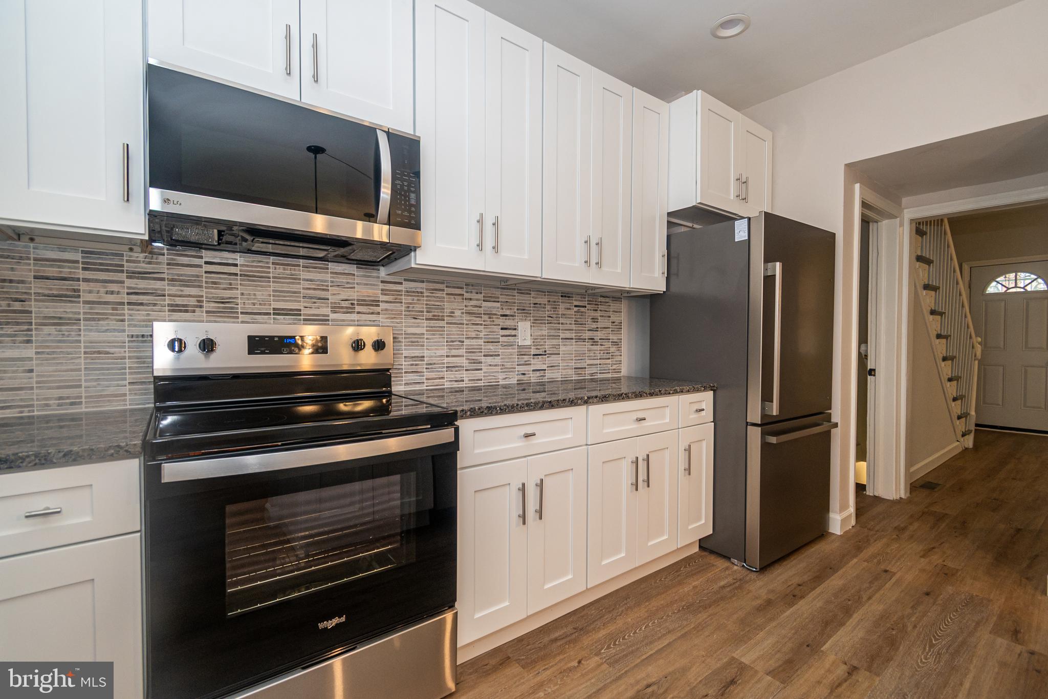 3716 Columbus Drive Baltimore, MD 21215 - Photo 10 of 36 a kitchen with stainless steel appliances a stove microwave and refrigerator