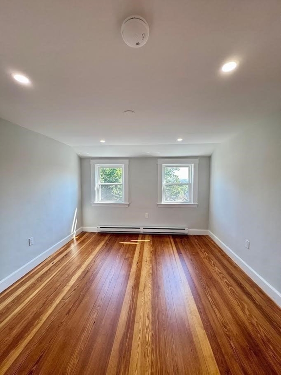 37 Fountain Road Arlington, MA 02476 - Photo 14 of 28 an empty room with wooden floor and windows