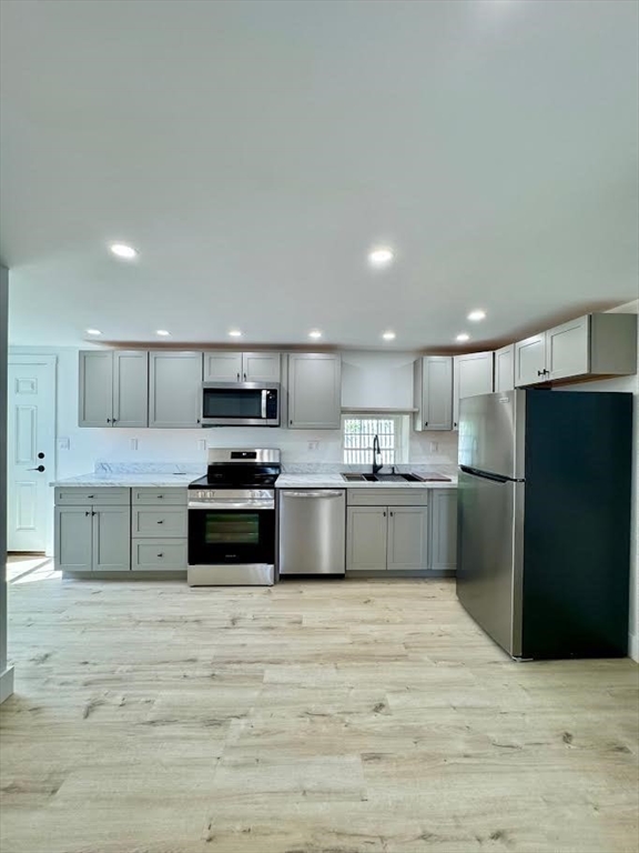 37 Fountain Road Arlington, MA 02476 - Photo 23 of 28 a large kitchen with stainless steel appliances kitchen island a large counter top and a stove top oven