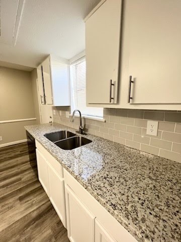 a kitchen with sink a stove and cabinets