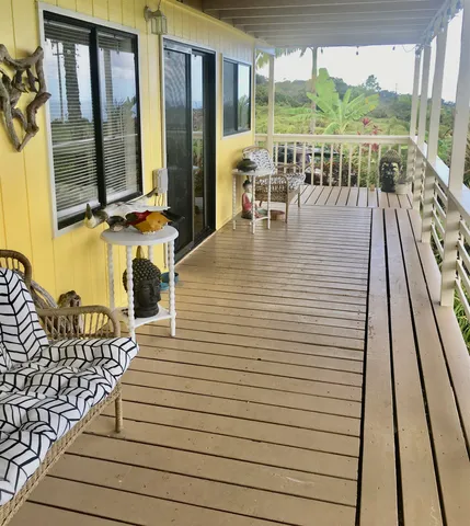 a view of balcony with chairs and wooden floor