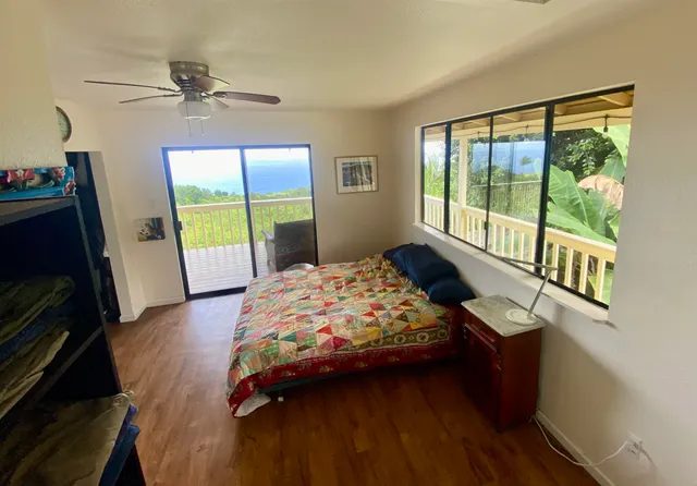 a bedroom with a bed a fireplace and a large window