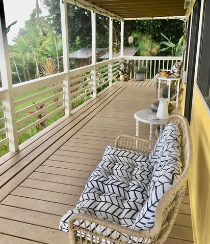 a view of a balcony with wooden floor