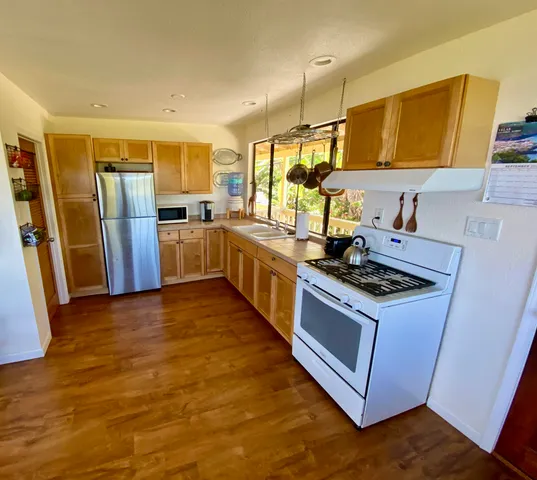 a kitchen with stainless steel appliances granite countertop a stove and a refrigerator
