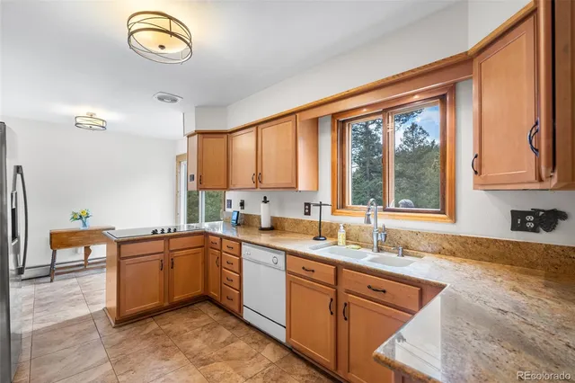 a kitchen with a stove a sink and a refrigerator