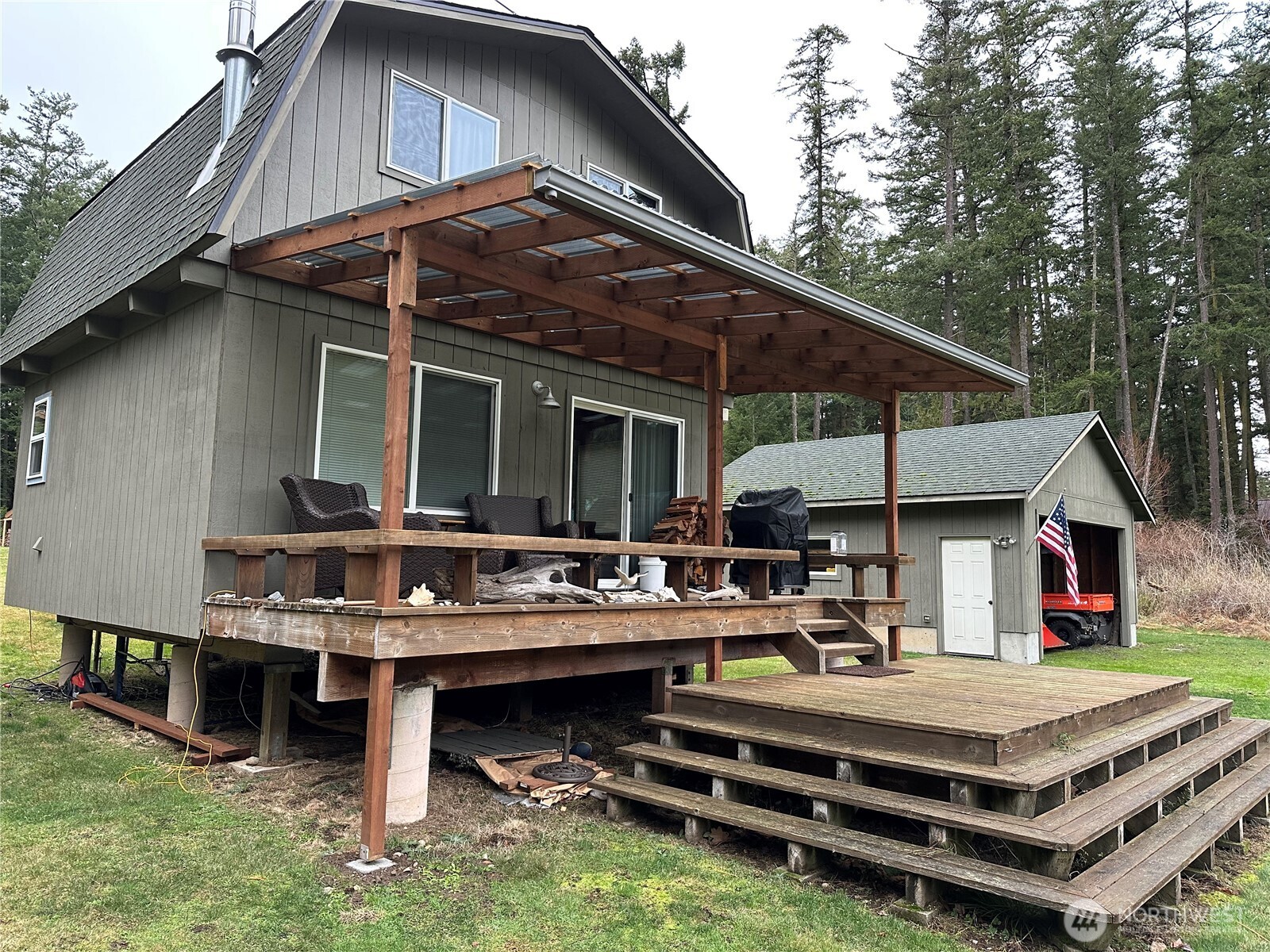 281 Maritime Road Blakely Island, WA 98222 - Photo 2 of 8 a view of the house with a chairs and table in a patio
