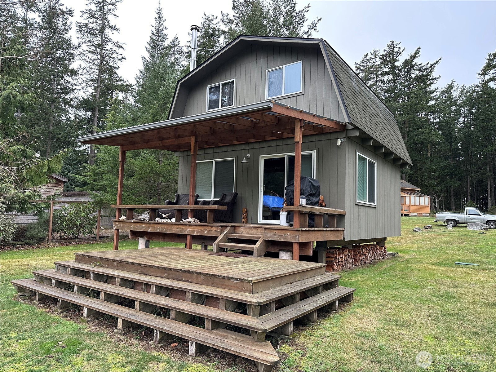 281 Maritime Road Blakely Island, WA 98222 - Photo 3 of 8 a view of a house with backyard sitting area and garden