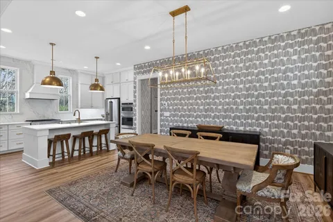 a kitchen with stainless steel appliances granite countertop a kitchen island a stove and a refrigerator