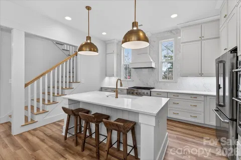 a kitchen with stainless steel appliances a stove a refrigerator and a window