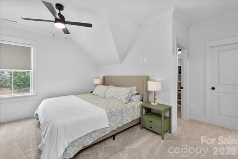 a bed room with a bed and a chandelier