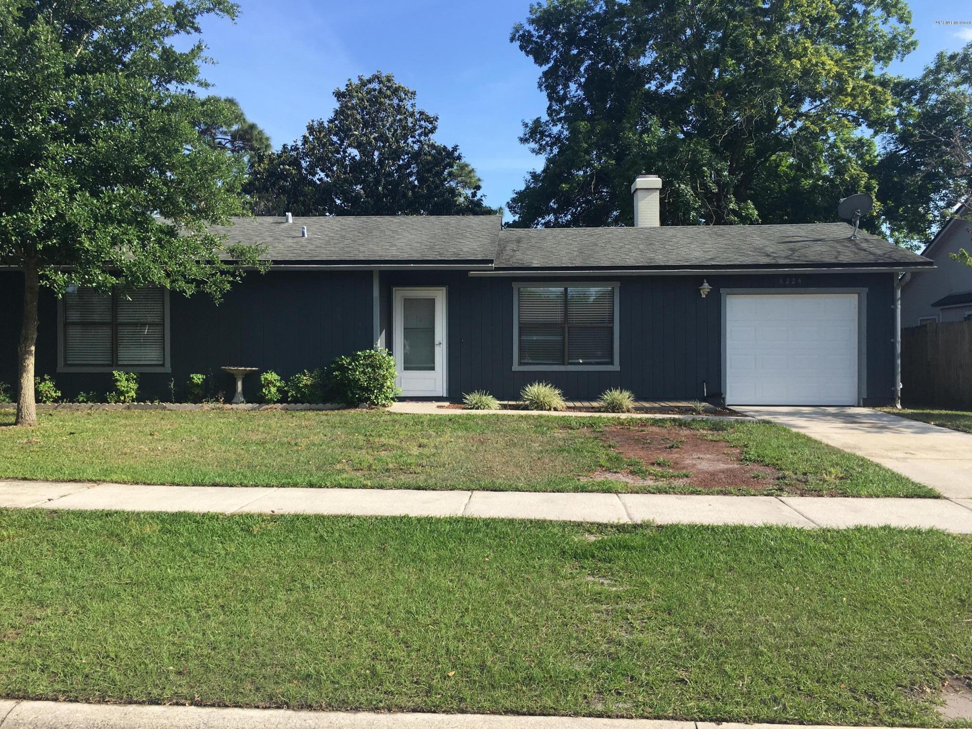 8224 Pear Road Jacksonville, FL 32210 - Photo 1 of 7 a front view of a house with a yard