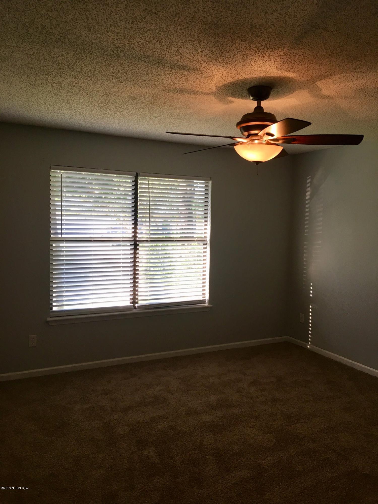 8224 Pear Road Jacksonville, FL 32210 - Photo 6 of 7 a view of a livingroom with a ceiling fan and window
