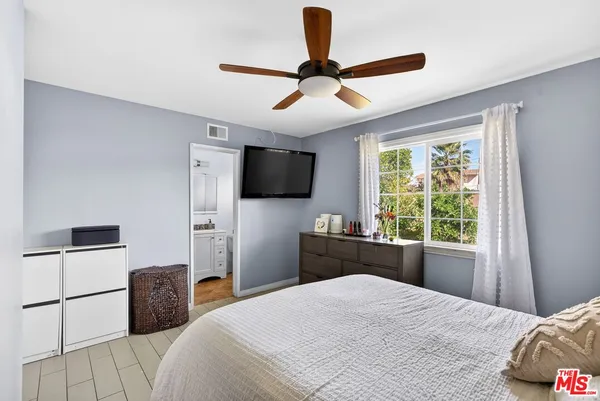 a bedroom with a bed and a television