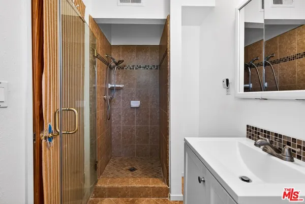 a bathroom with a sink and a shower