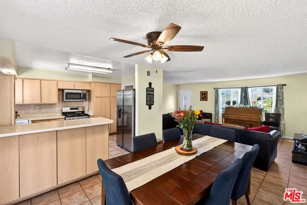 a view of a dining room with furniture a chandelier and wooden floor