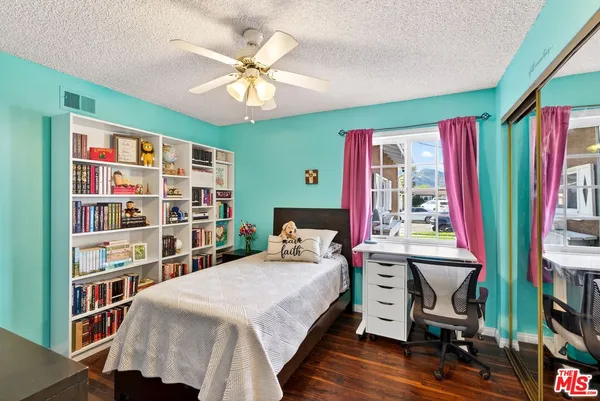a bedroom with a bed and a bookshelf