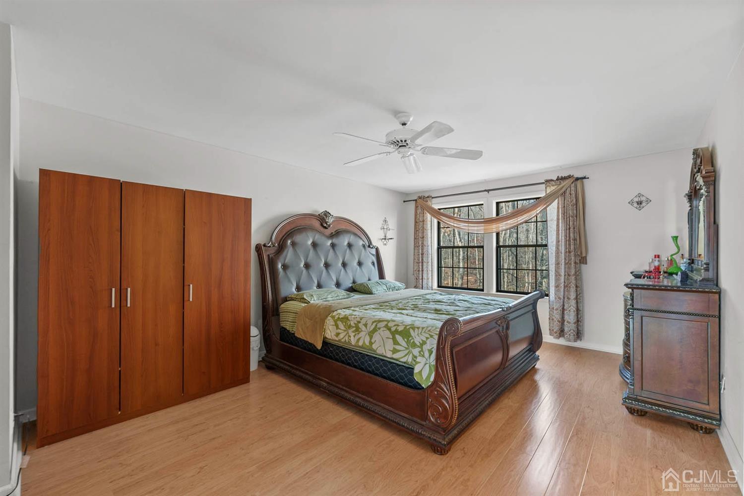 4302 Springbrook Drive Edison, NJ 08820 - Photo 22 of 44 a bed sitting in a bedroom next to a window