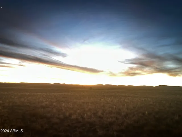 a view of a mountain range in a cloudy sky