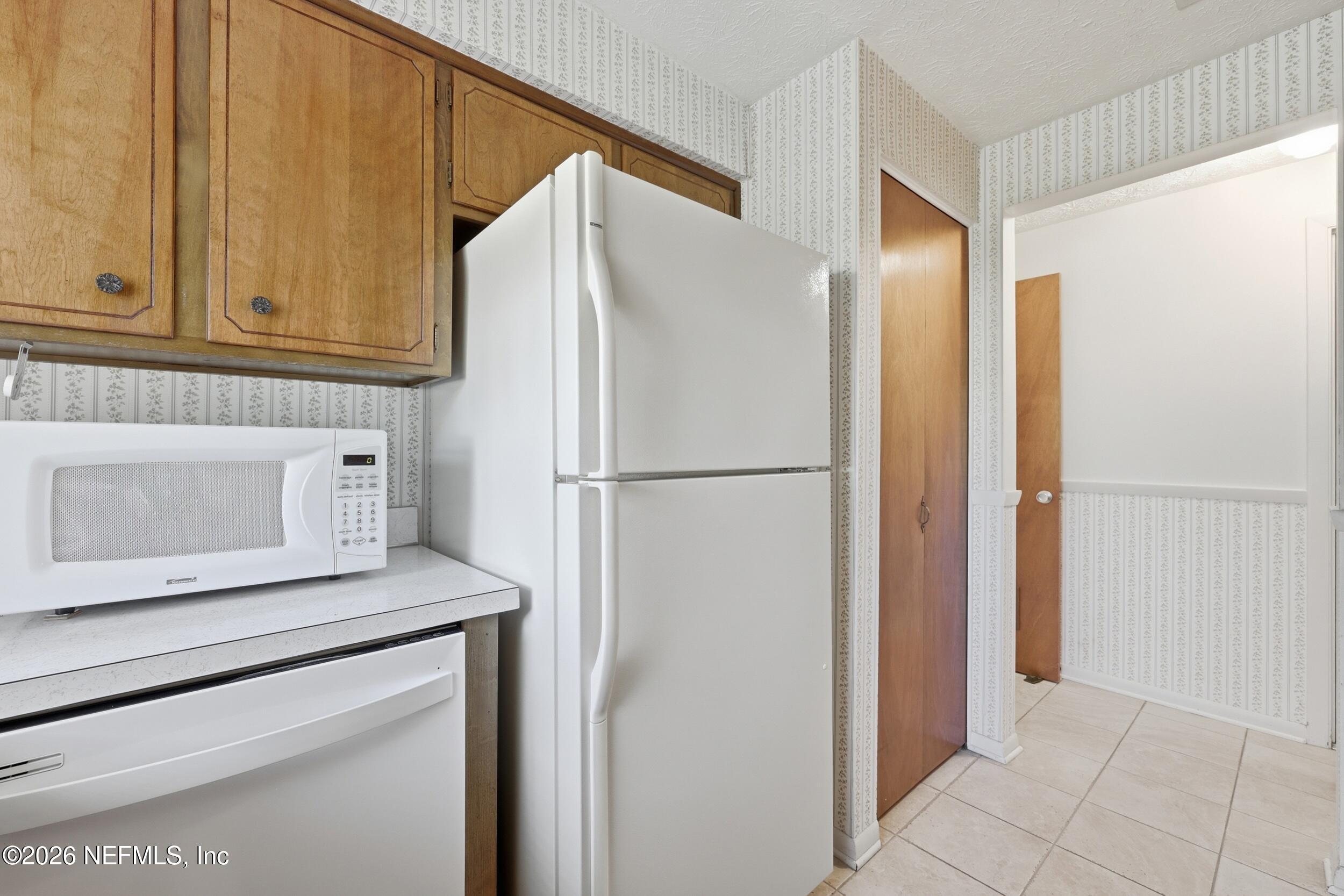 3519 Peoria Road Orange Park, FL 32065 - Photo 13 of 43 a white refrigerator freezer and a stove sitting inside of a kitchen