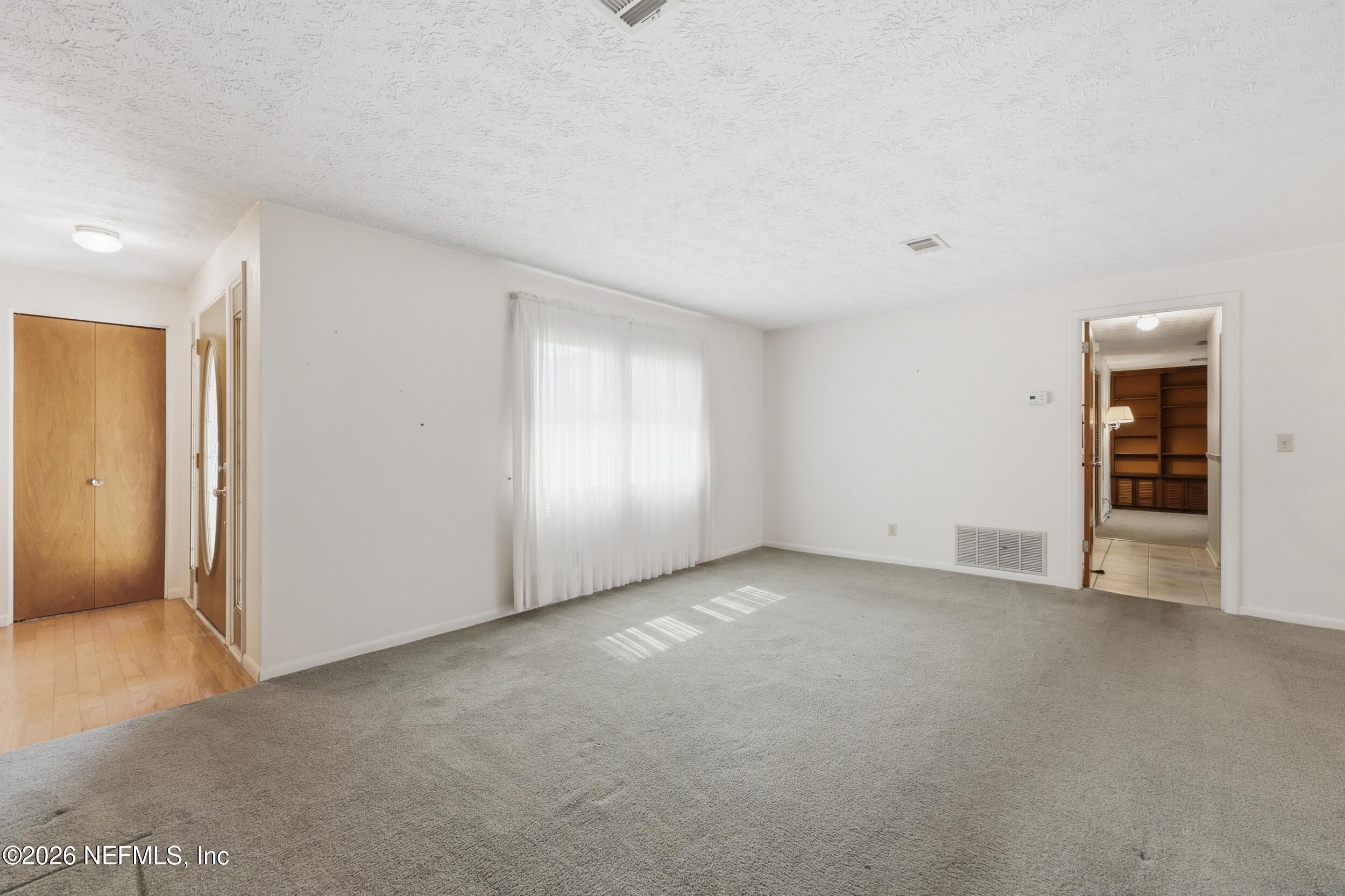 3519 Peoria Road Orange Park, FL 32065 - Photo 16 of 43 an empty room with closet and windows
