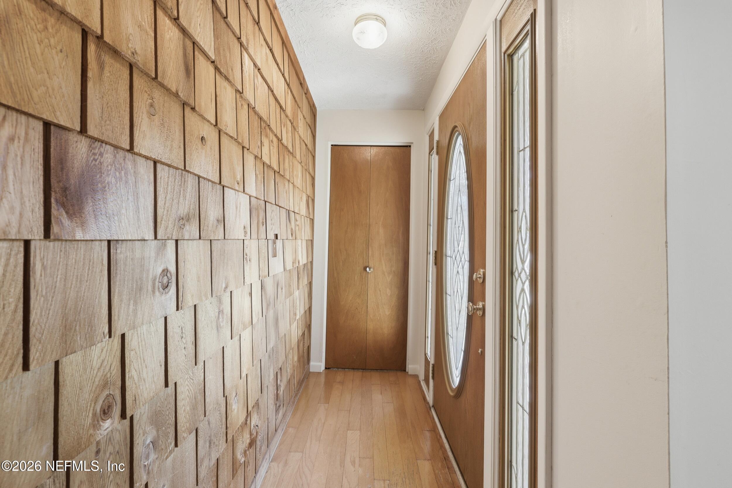3519 Peoria Road Orange Park, FL 32065 - Photo 2 of 43 a view of a hallway with wooden floor and staircase