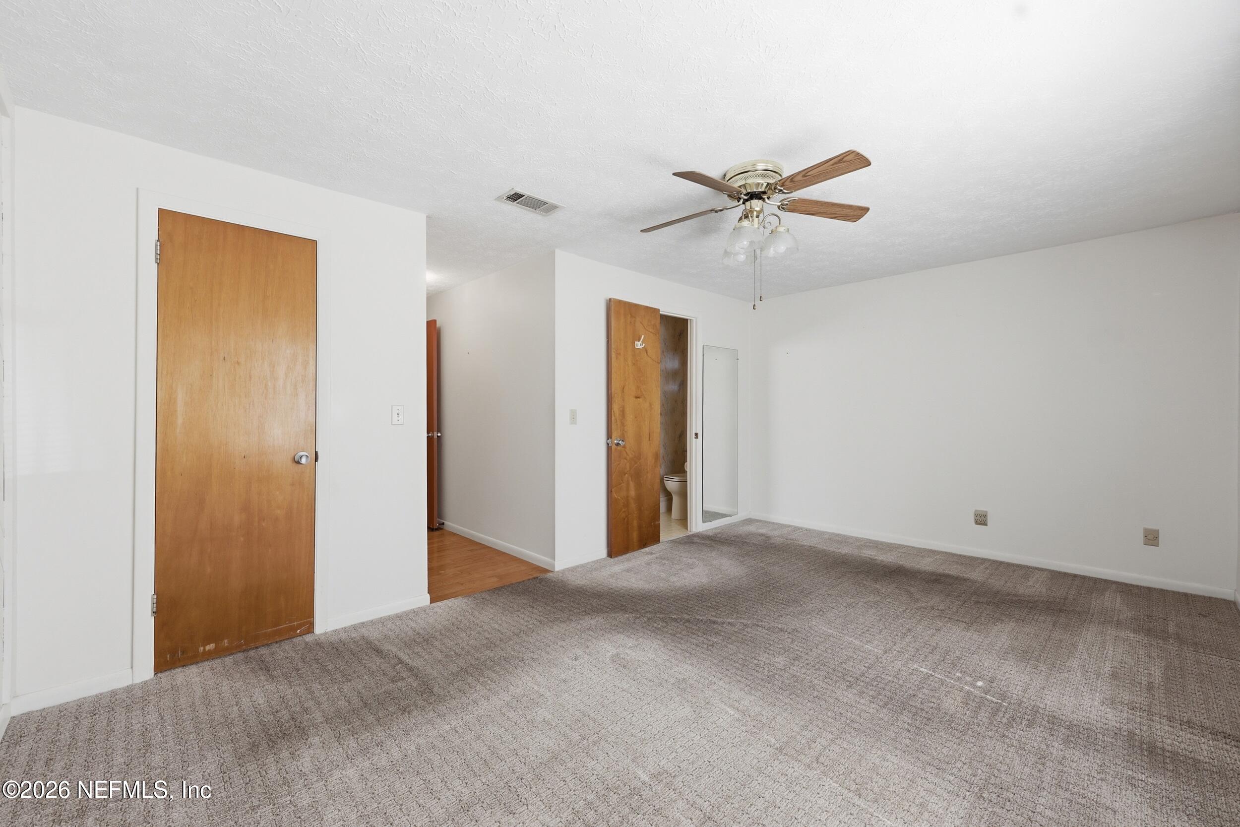 3519 Peoria Road Orange Park, FL 32065 - Photo 21 of 43 a view of a big room with closet and a ceiling fan