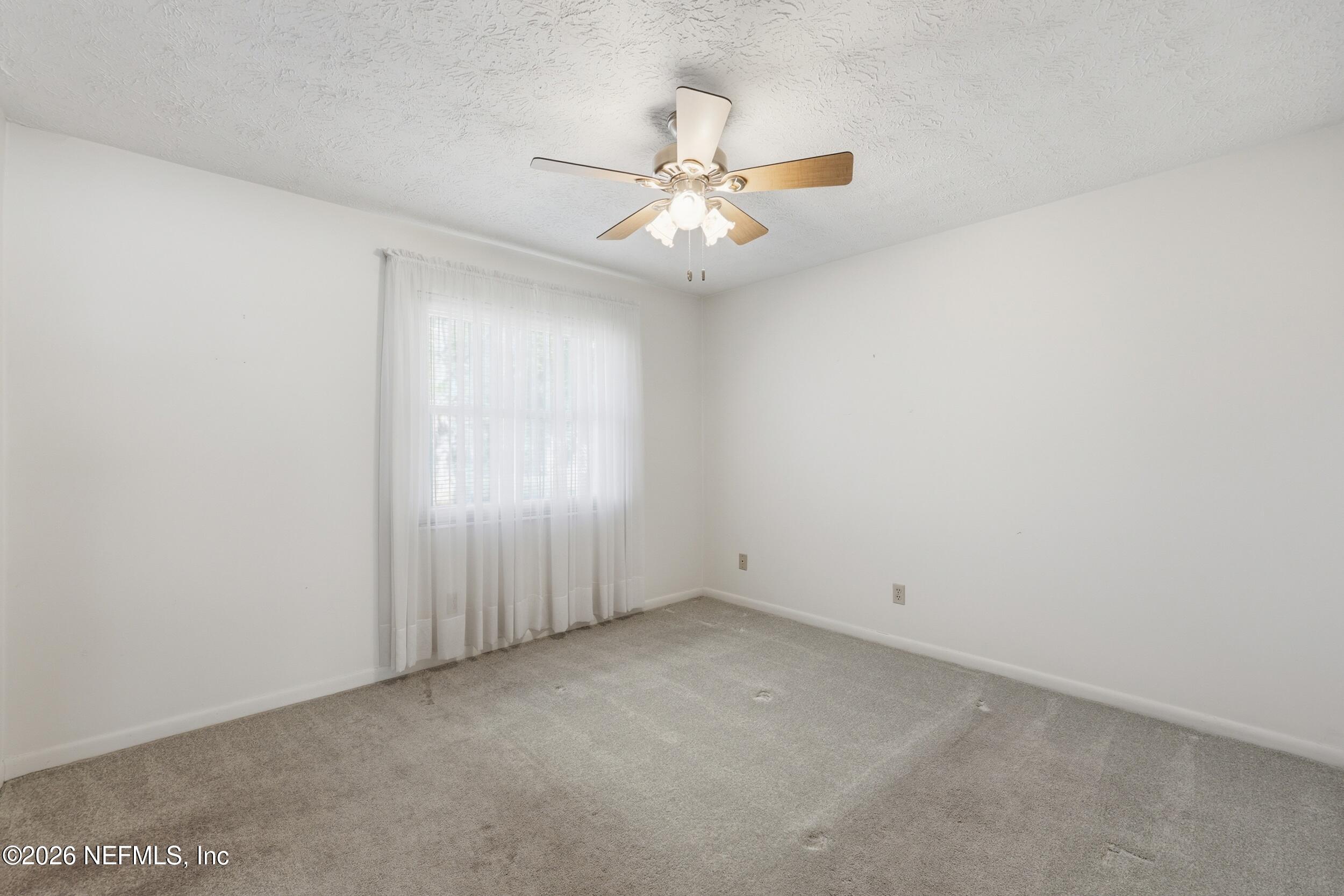 3519 Peoria Road Orange Park, FL 32065 - Photo 26 of 43 an empty room with a window and a ceiling fan