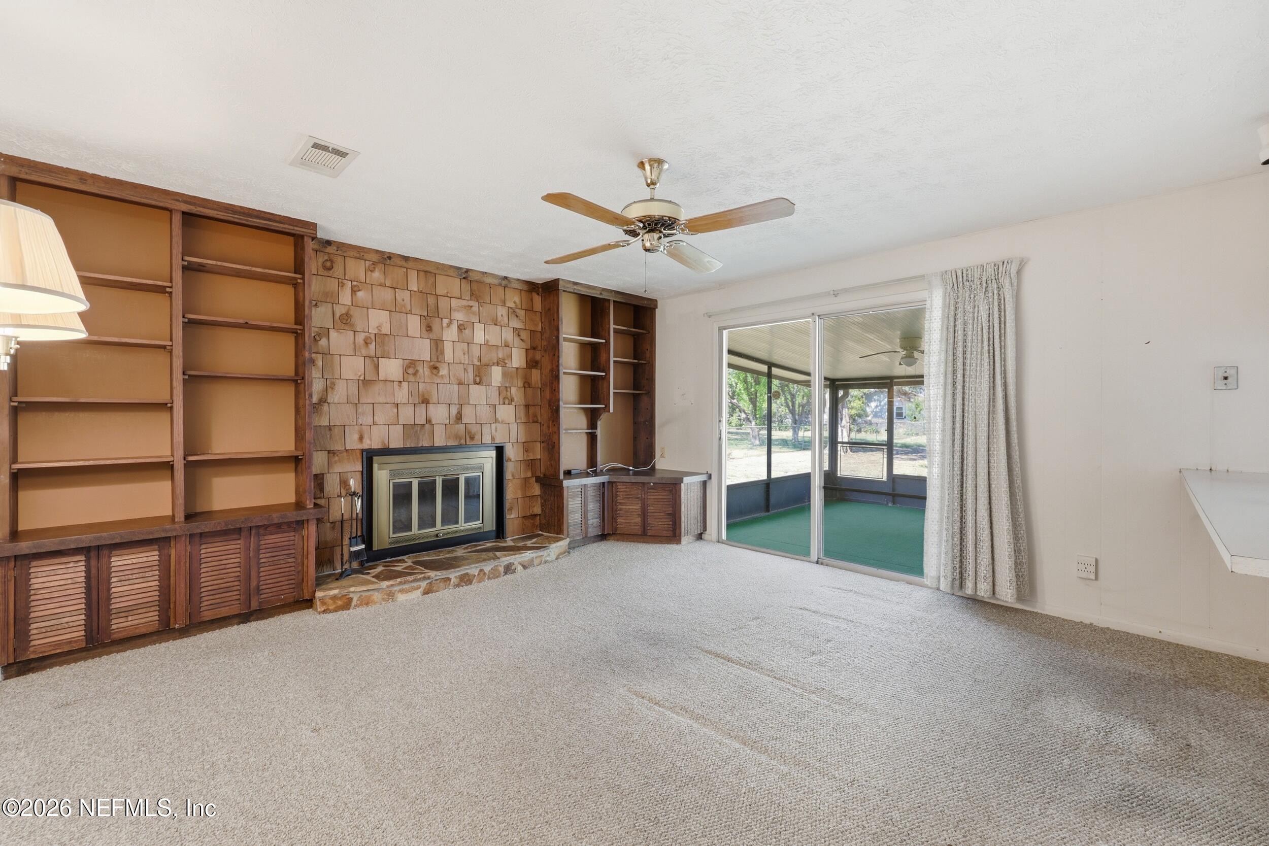 3519 Peoria Road Orange Park, FL 32065 - Photo 4 of 43 a view of a livingroom with a fireplace and window