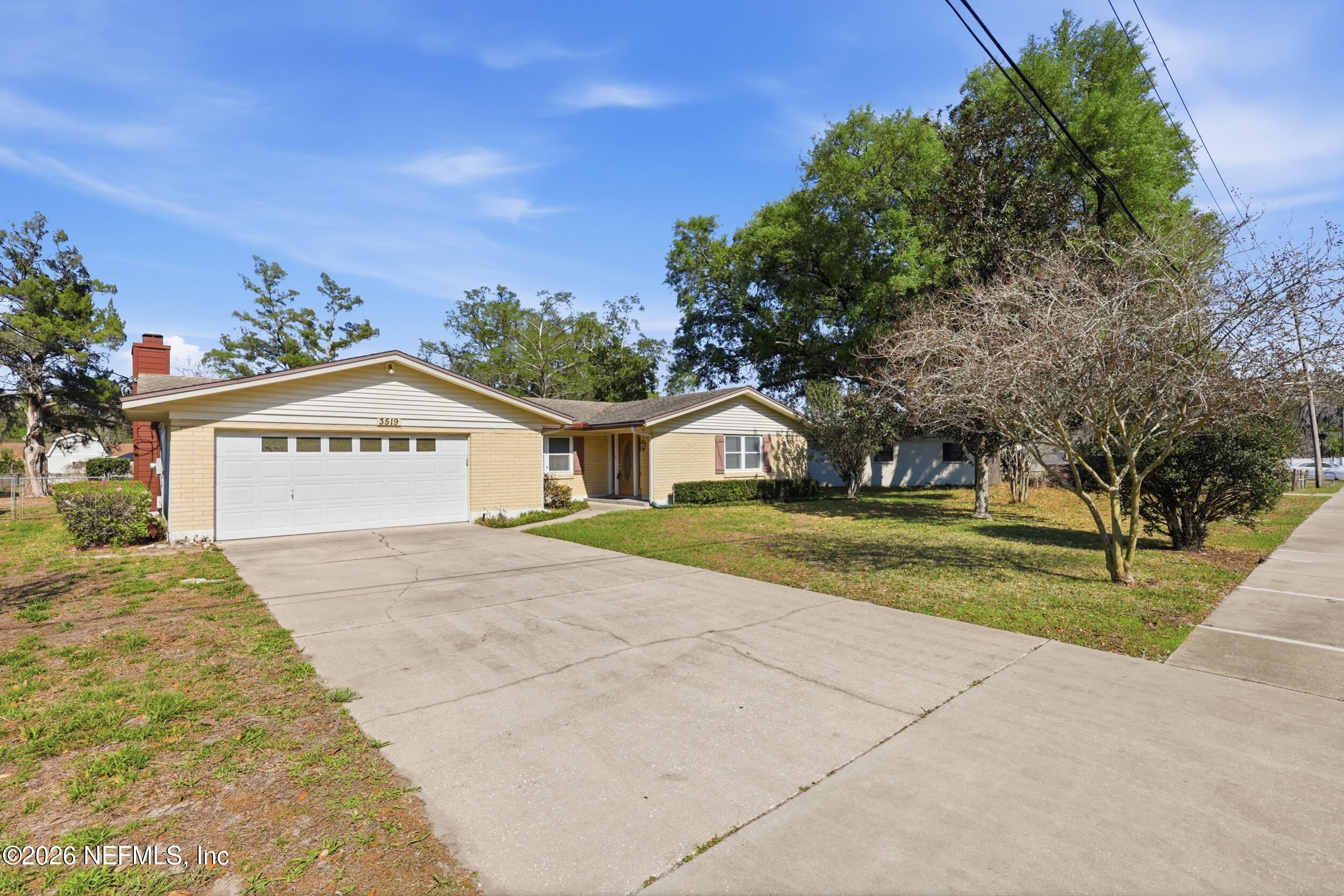 3519 Peoria Road Orange Park, FL 32065 - Photo 41 of 43 a view of a house with a yard and potted plants