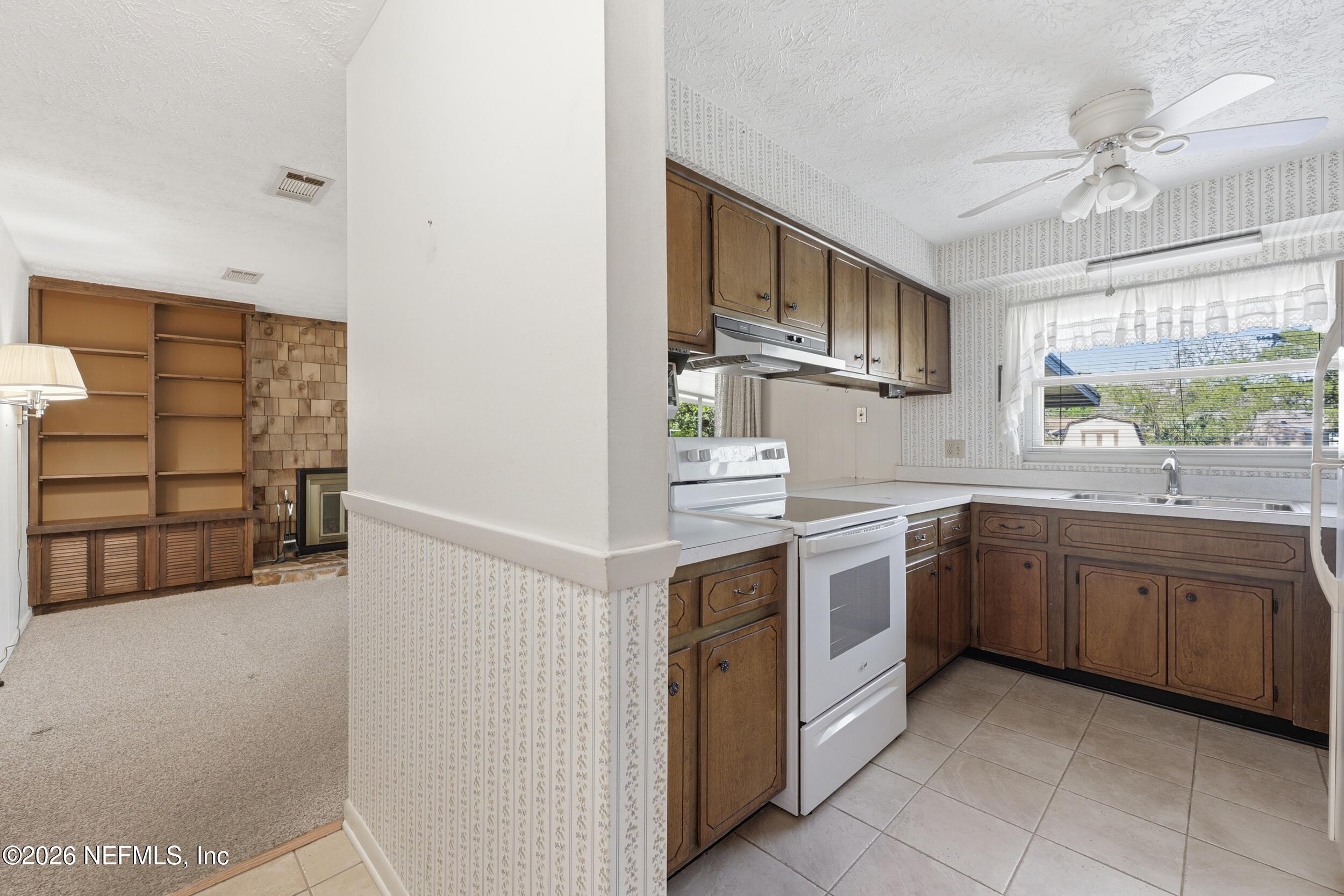 3519 Peoria Road Orange Park, FL 32065 - Photo 9 of 43 a kitchen with stainless steel appliances granite countertop a sink and cabinets