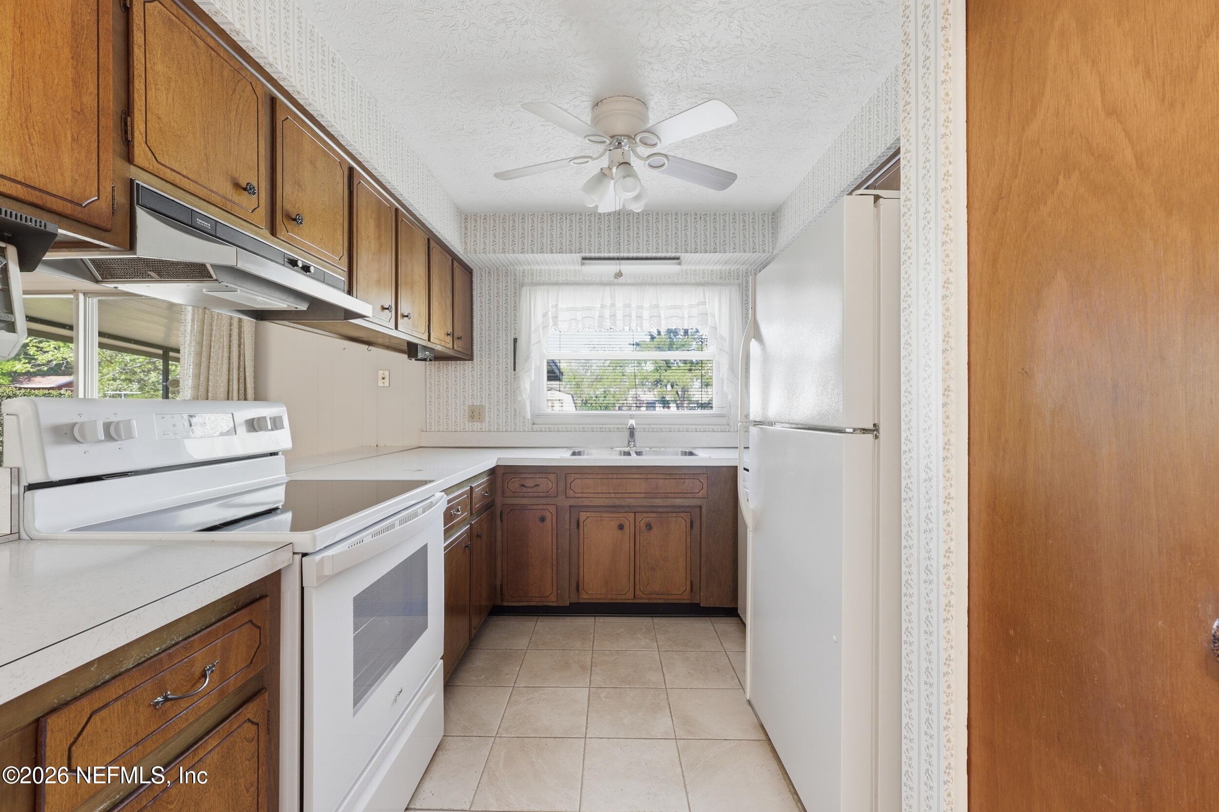 3519 Peoria Road Orange Park, FL 32065 - Photo 10 of 43 a kitchen with granite countertop a sink stove and refrigerator