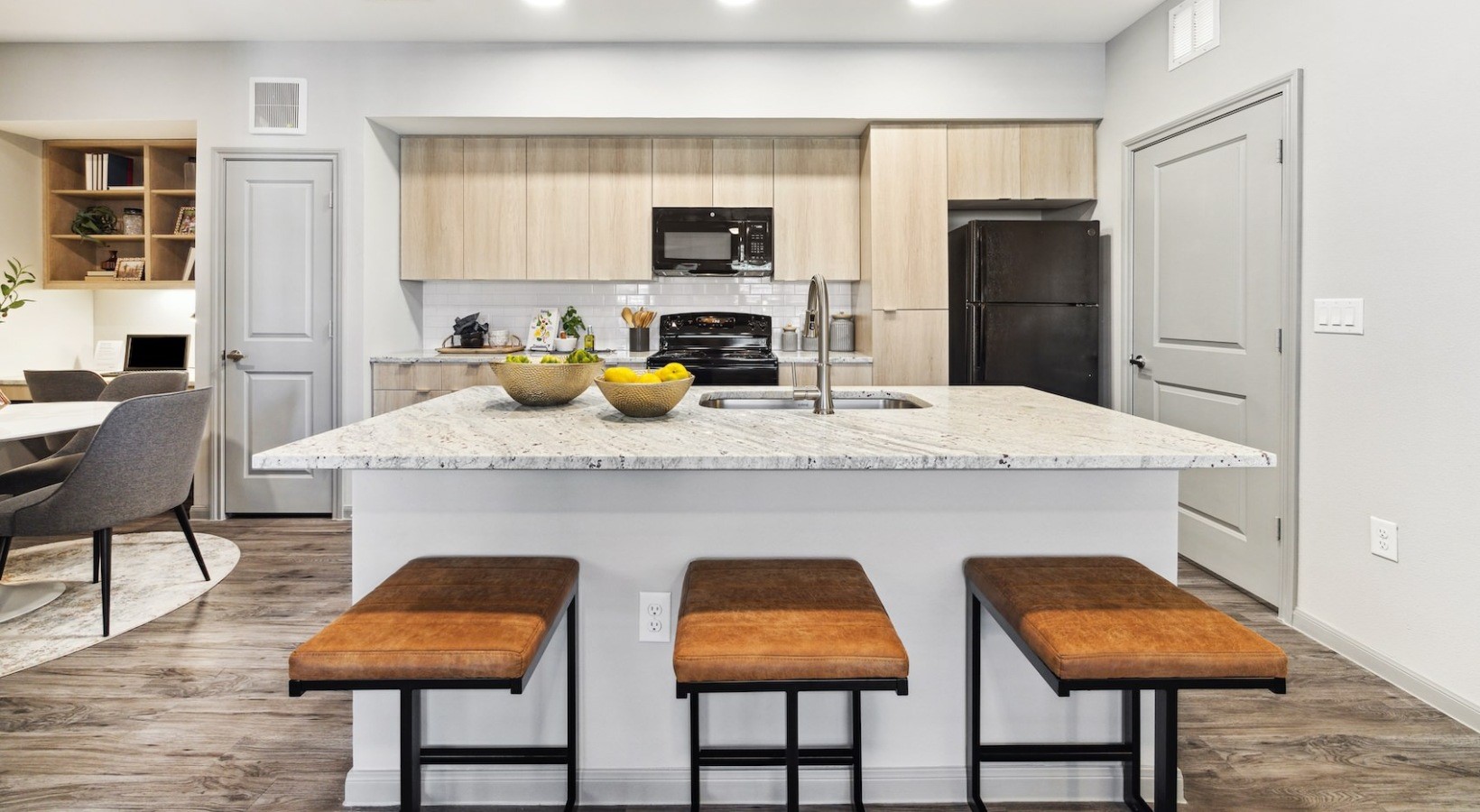 12752 North Houston Rosslyn Road, Unit 115 Houston, TX 77086 - Photo 4 of 14 a kitchen with stainless steel appliances granite countertop a kitchen island a stove a table and chairs